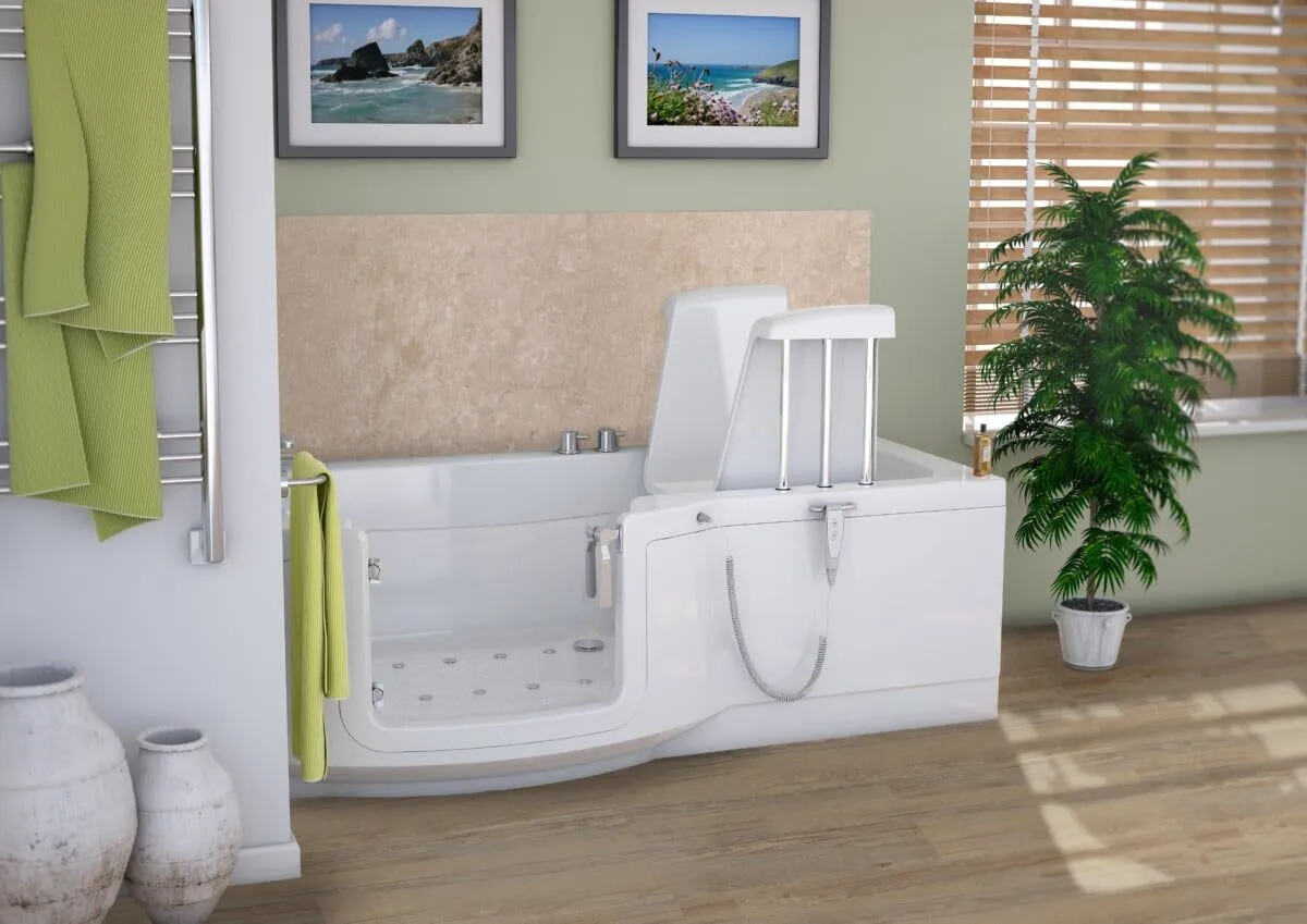 Modern bathroom with a white walk-in bathtub, green towels, two vases, a leafy plant, wooden blinds, and two framed beach photos on a light green wall. The tub features a built-in seat and safety handrails.