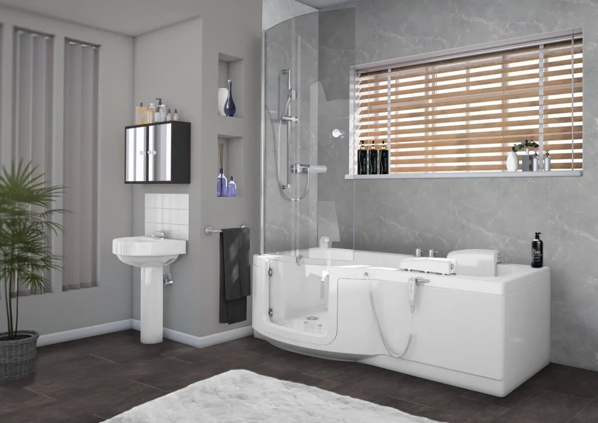 Modern bathroom with a corner walk-in bathtub, handheld shower, wall-mounted sink, mirrored cabinet, built-in shelves with toiletries, a plant, and a window with wooden blinds, all in neutral tones.