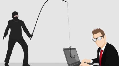 A masked person in black holds a fishing rod with a hook aimed at a laptop, while a person in a suit and glasses types on the laptop, symbolizing a phishing cyberattack.