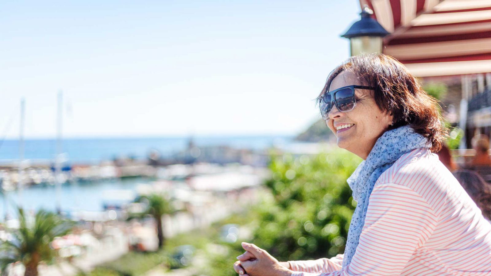 A smiling tourist who admire the view over the port