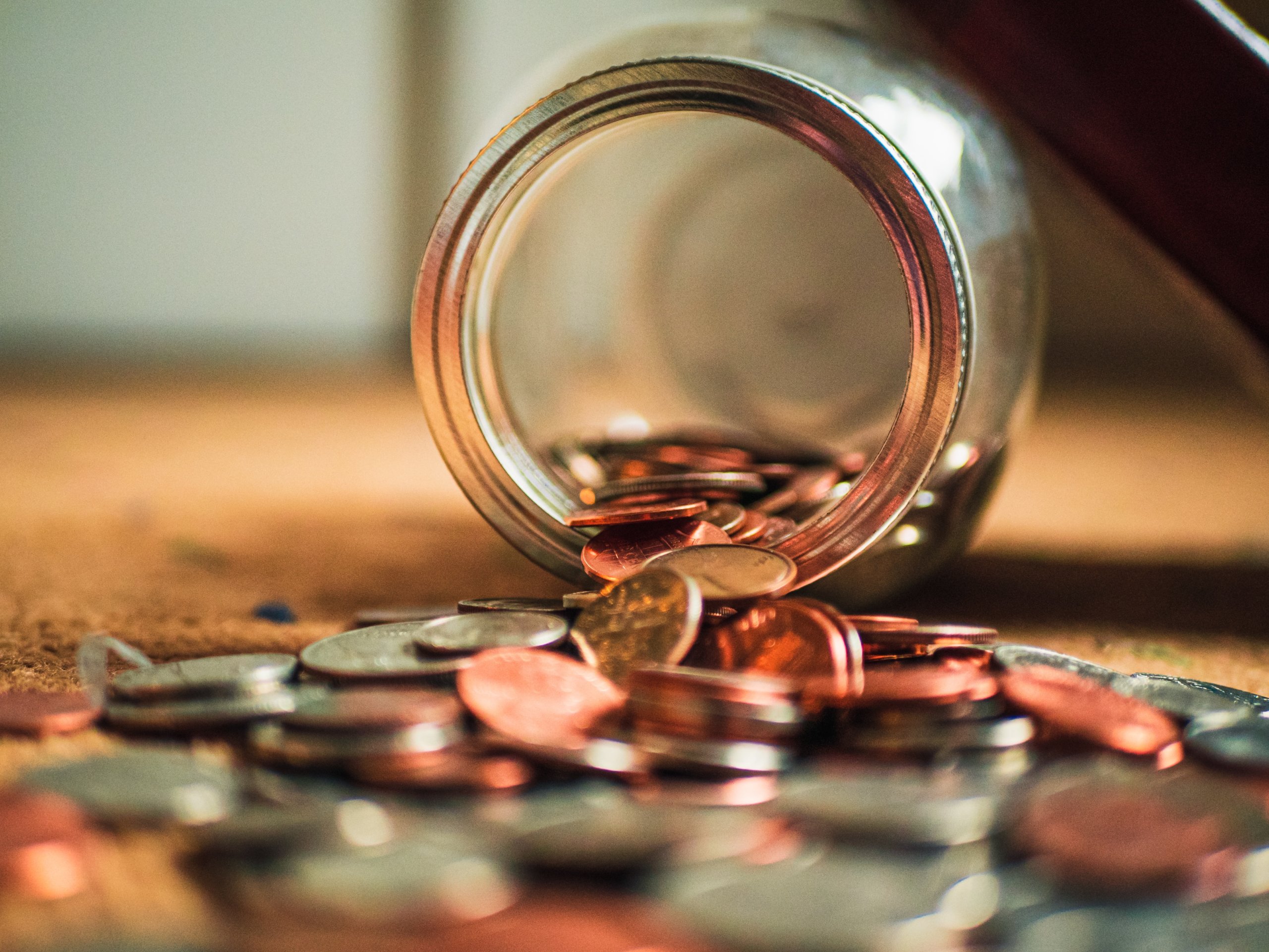 Money falling out of a jar