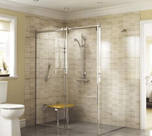 An image of a large walk in shower in a beige tiled bathroom