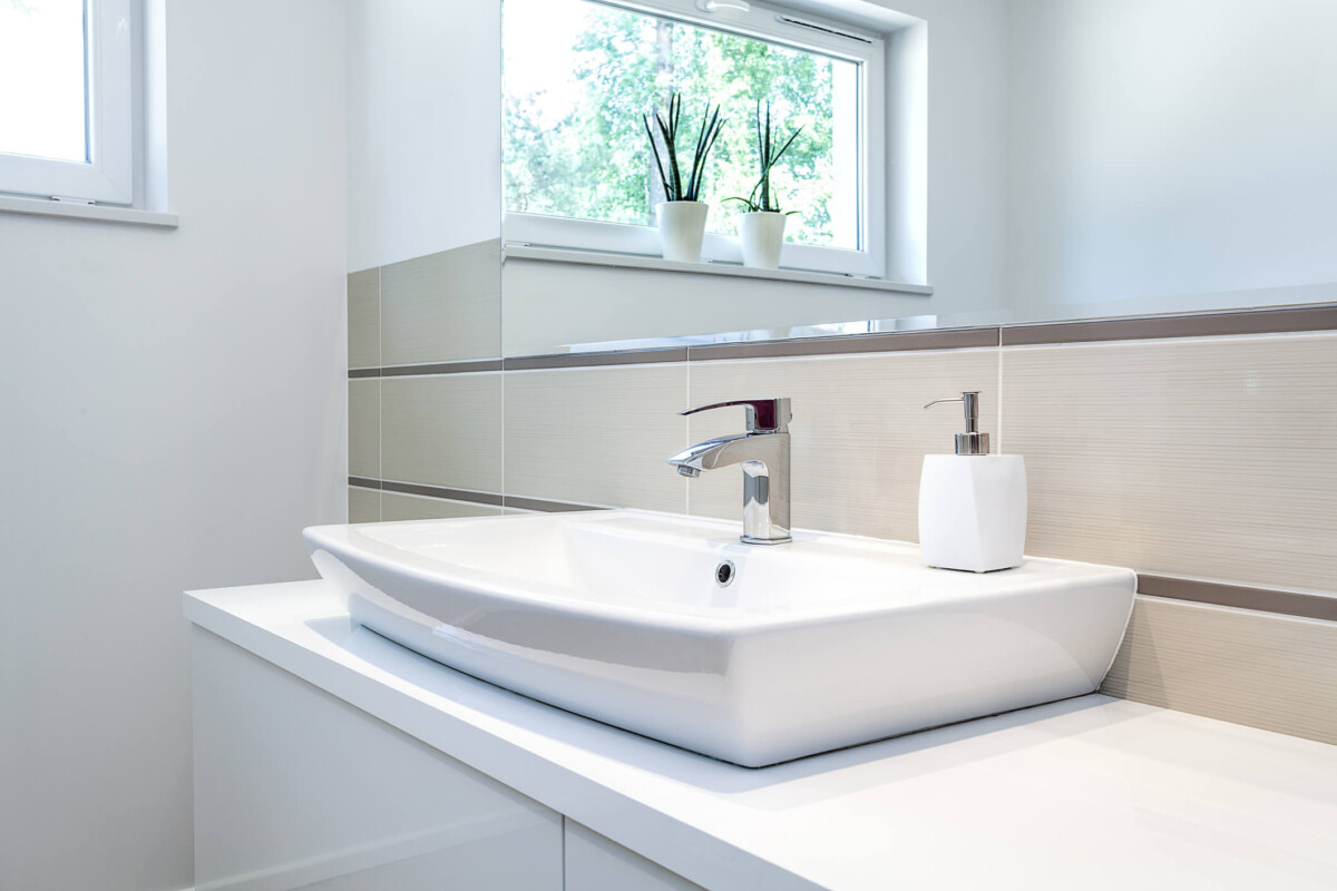 sink shelves around sink basin in white bathroom.