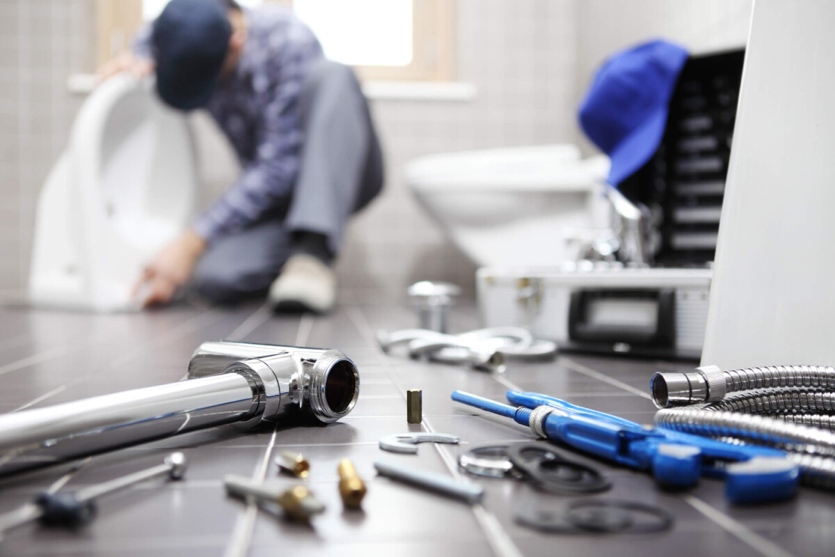 Plumber at work in a bathroom.