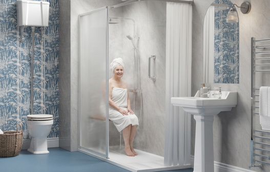 Woman sat in walk in shower